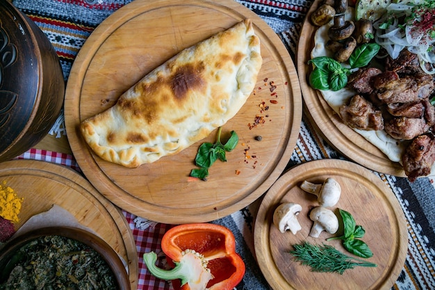 Traditional Georgian adjara khachapuri and Kolkh khachapuri on the table. Homemade baking