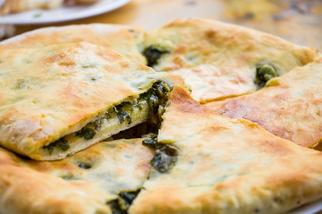 Traditional Georgian dish Fkhlovana with cheese and greens, daylight