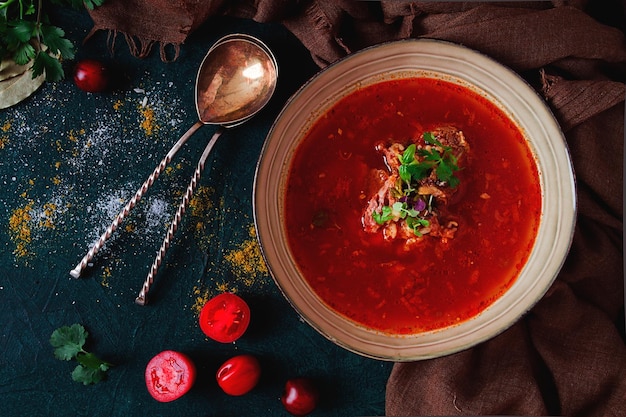 Traditional Georgian dish spicy tomato Kharcho soup on a dark background no people top view