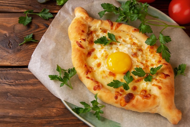 Traditional Georgian pastry khachapuri. Open pie with mozzarella and egg.