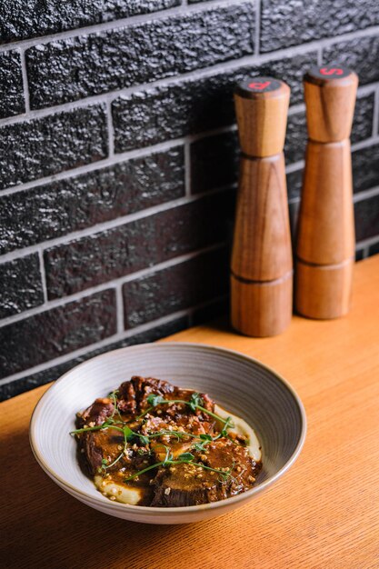 Traditional german braised veal cheeks in brown sauce with mashed potatoes