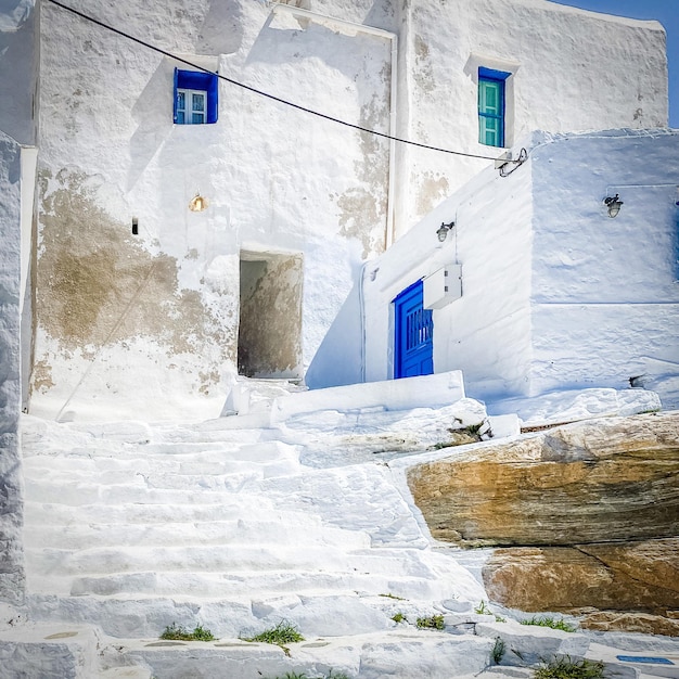 Traditional greek architecture Stairs whitewashed walls and blue doors at Kastro village