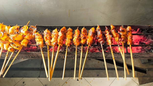 Traditional grilled satay with burning charcoal fire