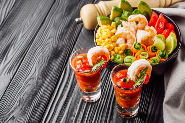 traditional hawaiian shrimp poke bowl on black wooden rustic background