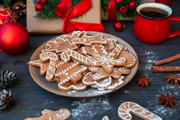 Traditional homemade gingerbread cookies and a cup of coffee among the Christmas decor Christmas mood holiday atmosphere