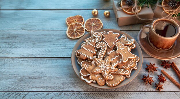 Traditional homemade gingerbread cookies and a cup of coffee on a sunny winter morning Home comfort Christmas mood holiday atmosphere