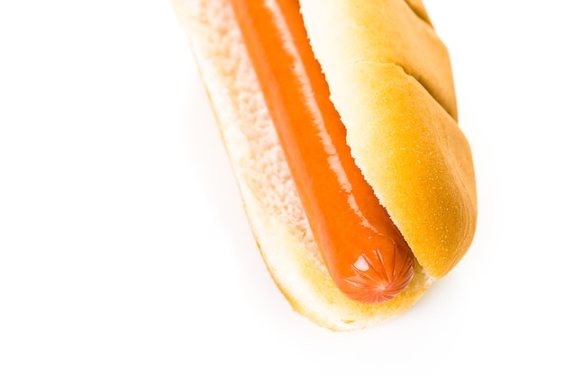 Traditional hot dogs on a white hot dog bun on a white background.