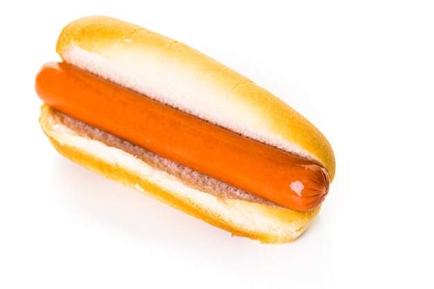 Traditional hot dogs on a white hot dog bun on a white background.