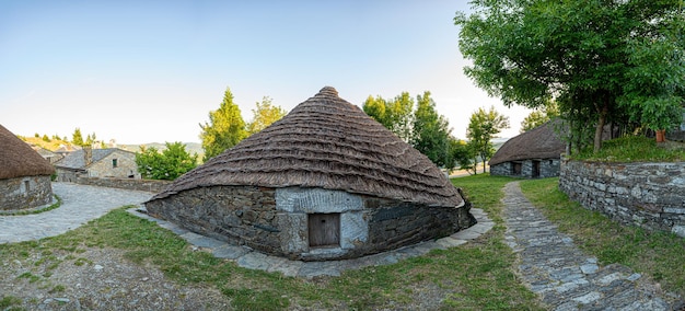 Traditional house in the town of O Cebreiro known as Palloza with thatched roof made of stone