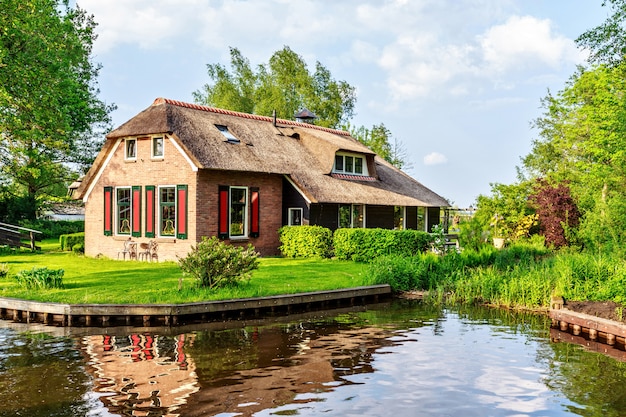 Traditional house with rustic thatched roof in Netherlands