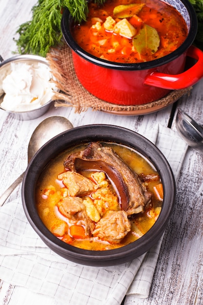 Traditional hungarian dish - bogracs goulash, stewed meat and vegetables in cauldron