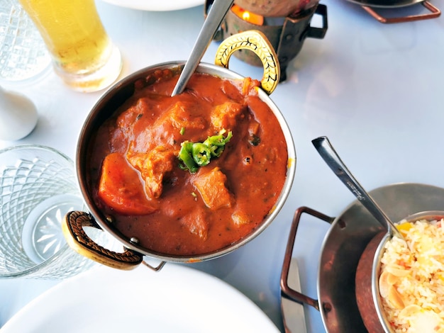 Traditional Indian curry lamb vindaloo in a copper bowl