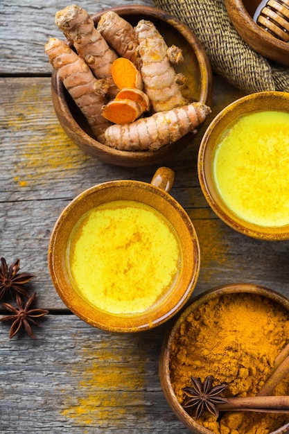 Traditional indian drink turmeric curcuma golden milk with ingredients