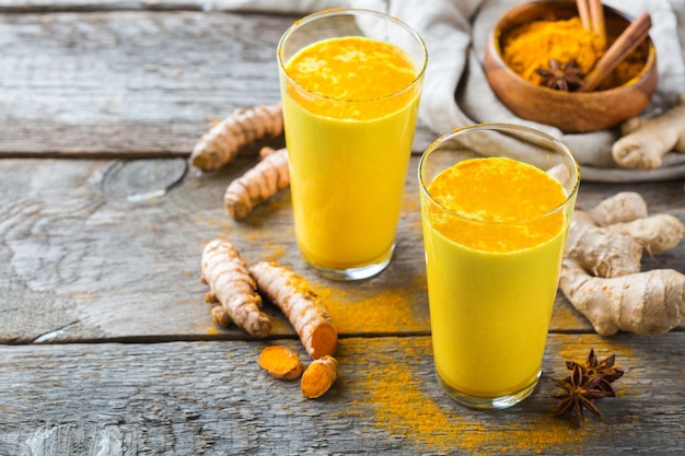 Traditional indian drink turmeric curcuma golden milk with ingredients