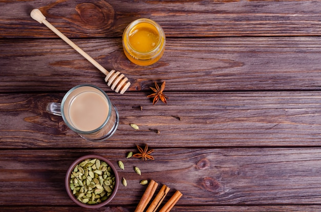 Traditional Indian tea Masala tea in a tall glass cup Ingredients for making tea