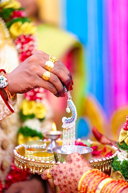 Traditional indian wedding ceremony, groom and bride hand