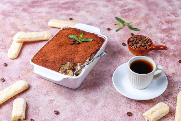 Traditional italian dessert tiramisu in ceramic plate,top view.