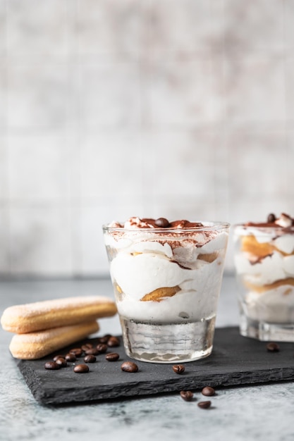 Traditional Italian dessert tiramisu Coffee flavored portion dessert decorated with cocoa