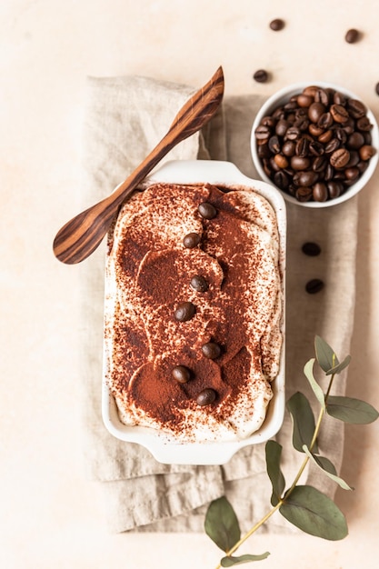 Traditional Italian dessert tiramisu made of ladyfingers and mascarpone in ceramic dish