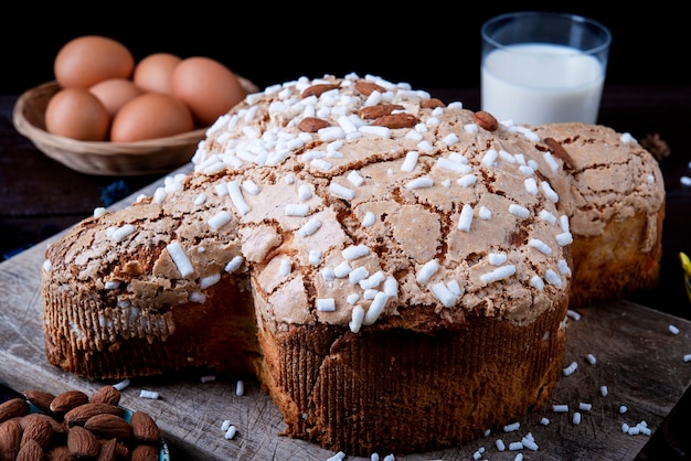 Traditional Italian desserts for Easter - Easter dove . Festive pastries with almonds and sugar icing dark surface Easter decor and eggs