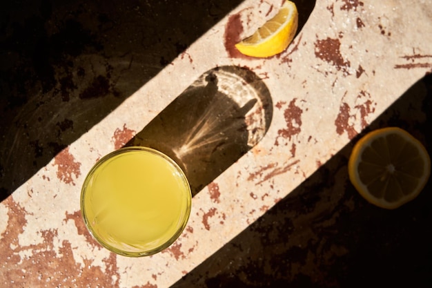 Traditional italian homemade lemon alcohol drink liqueur limoncello with pieces of lemon