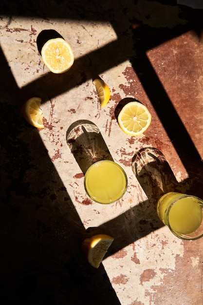 Traditional italian homemade lemon alcohol drink liqueur limoncello with pieces of lemon