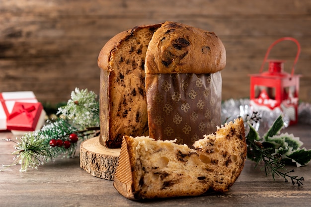 Traditional Italian panettone and Christmas ornament on rustic wooden table