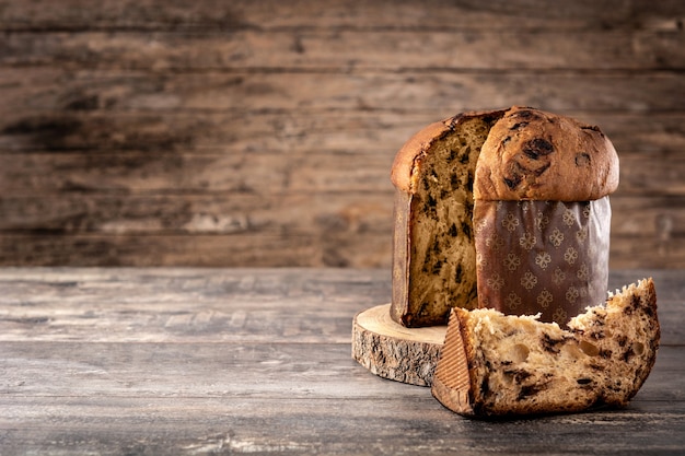 Traditional Italian panettone for Christmas on wooden table