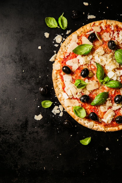 Traditional italian pizza on dark table