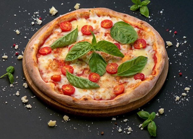 Traditional Italian pizza vegetables ingredients on a dark background Pizza is cooked in the oven