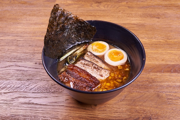 Traditional Japanese soup ramen, noodles, sliced chiken, eggs. Close up.