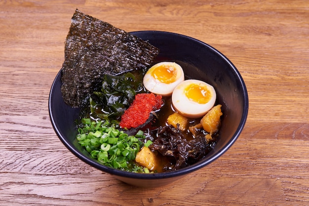 Traditional Japanese soup ramen, noodles, sliced chiken, eggs. Close up.