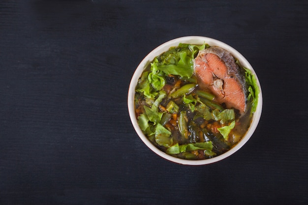 Traditional japanese soup on a red napkin on black 