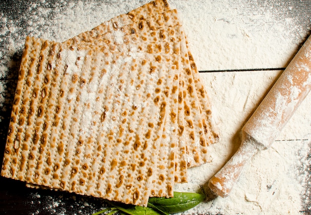 Traditional Jewish kosher matzo for Easter pesah on a wooden table