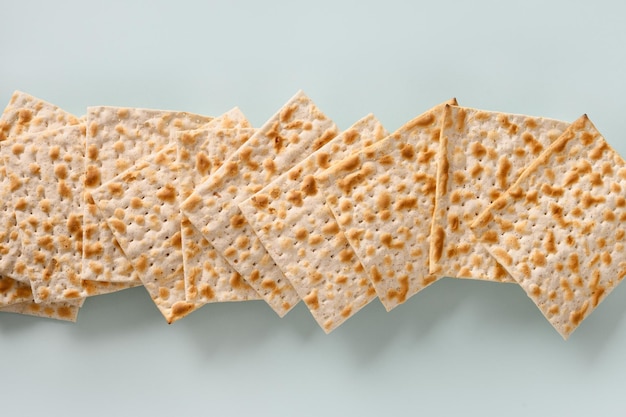 Traditional Jewish kosher matzo for passover on blue background