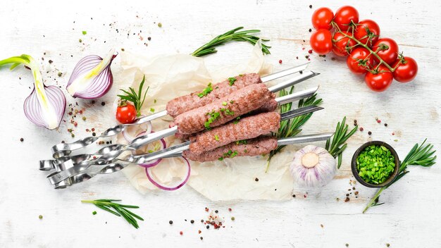 Traditional kebab with rosemary and onions Grilled veal skewers Top view Free space for your text