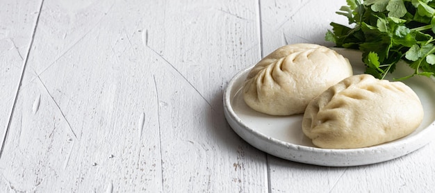 Traditional korean steamed pie pyanse or pigodi on white wooden background selective focus copy space