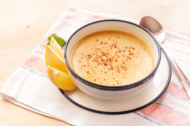 Traditional lentil soup in a white plate on a wooden table