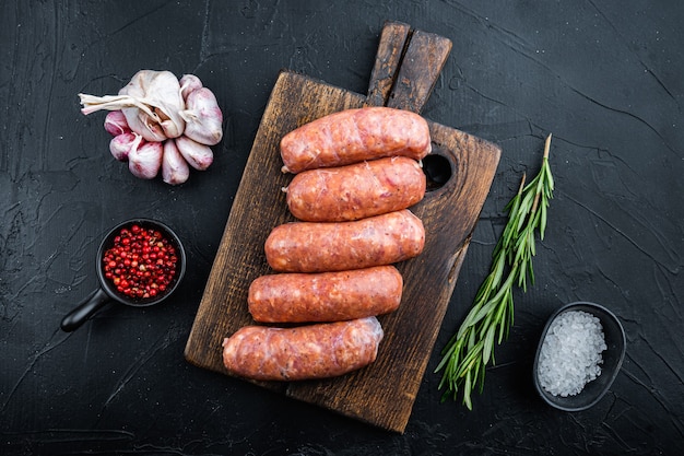 Traditional mest sausages, flat lay, on black table.