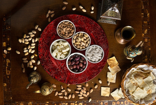 Traditional Middle Eastern food. Lebanese food. Arabian snacks, cheese, olives, nuts and seeds, lamp, top view