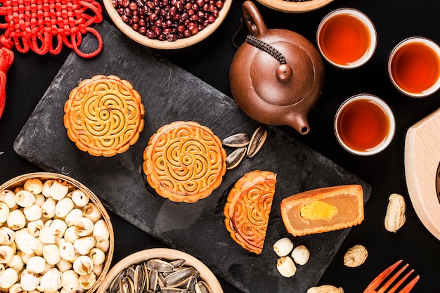 Traditional mooncakes on table setting with teacup.