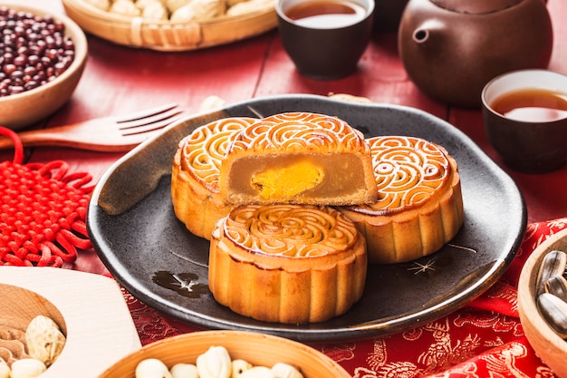 Traditional mooncakes on table setting with teacup.