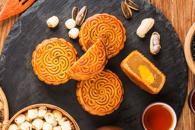 Traditional mooncakes on table setting with teacup. 