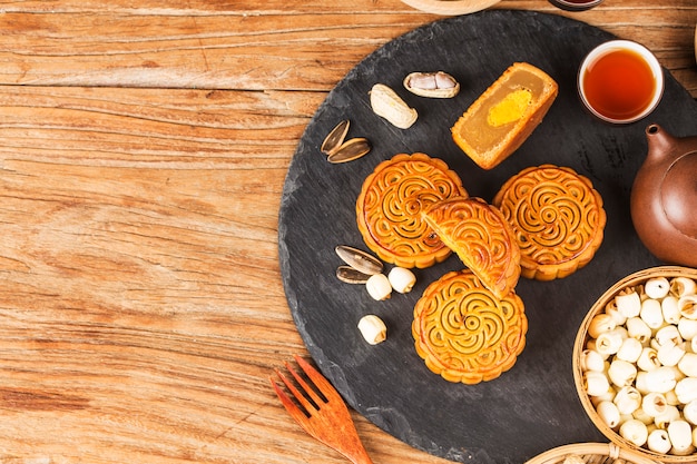 Traditional mooncakes on table setting with teacup. 