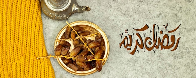 Traditional Moroccan Mint Tea with silver teapot Arabic drink and ripe dates with arabic text which