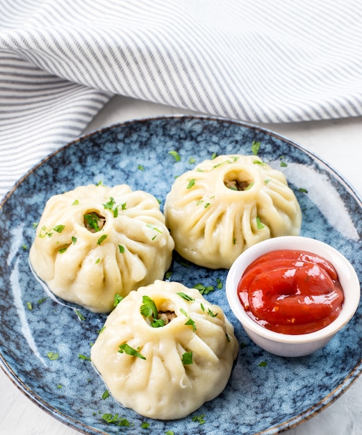 Traditional oriental food manti with meat on a plate