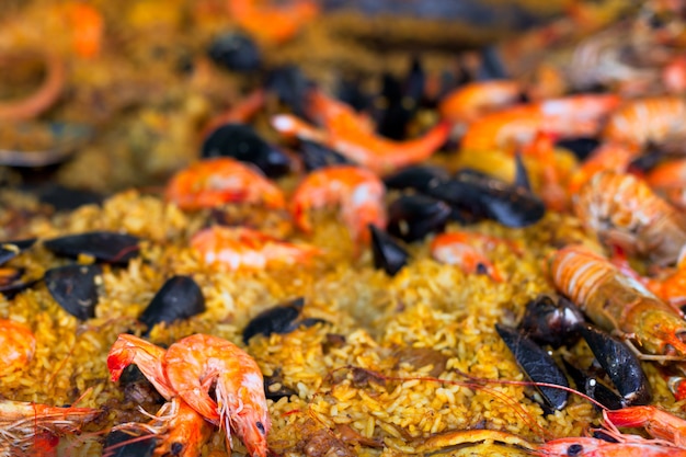 Traditional paella with seafood in a market. Shoted at Provence, France. Shot with selective focus