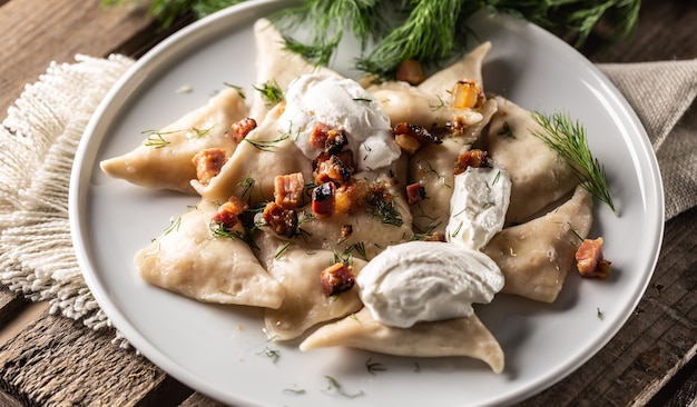 Traditional Polish, Ukrainian or Slovak pierogi dish with sour cream, bacon and dill.