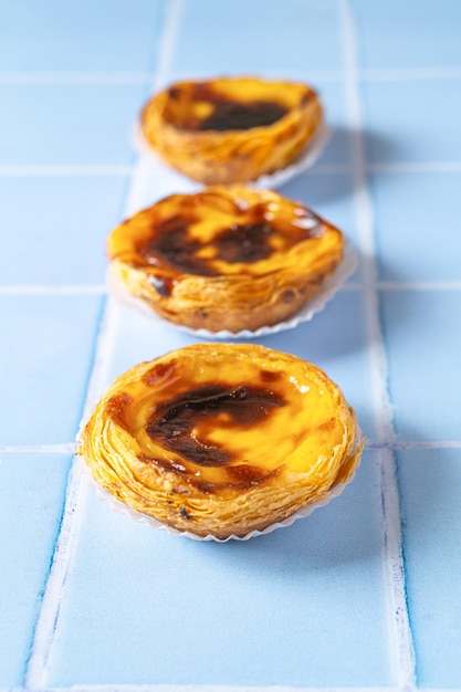 Traditional Portuguese dessert Pastel de nata on blue tile