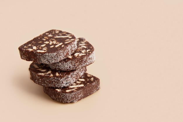 Traditional portuguese dessert Salame de Chocolate on beige background in minimal style Restaurant bakery menu